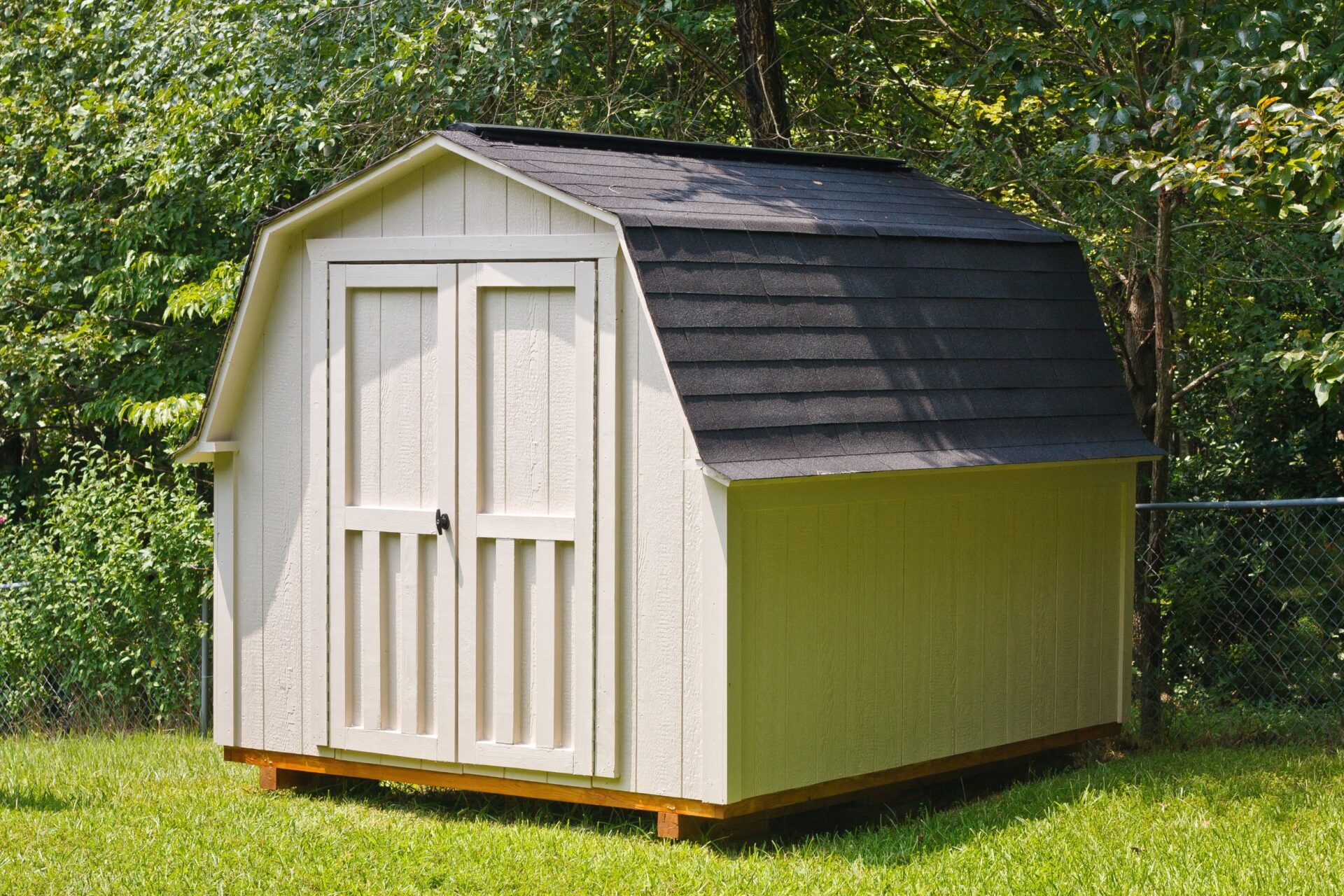 A wood utility shed in a back yard